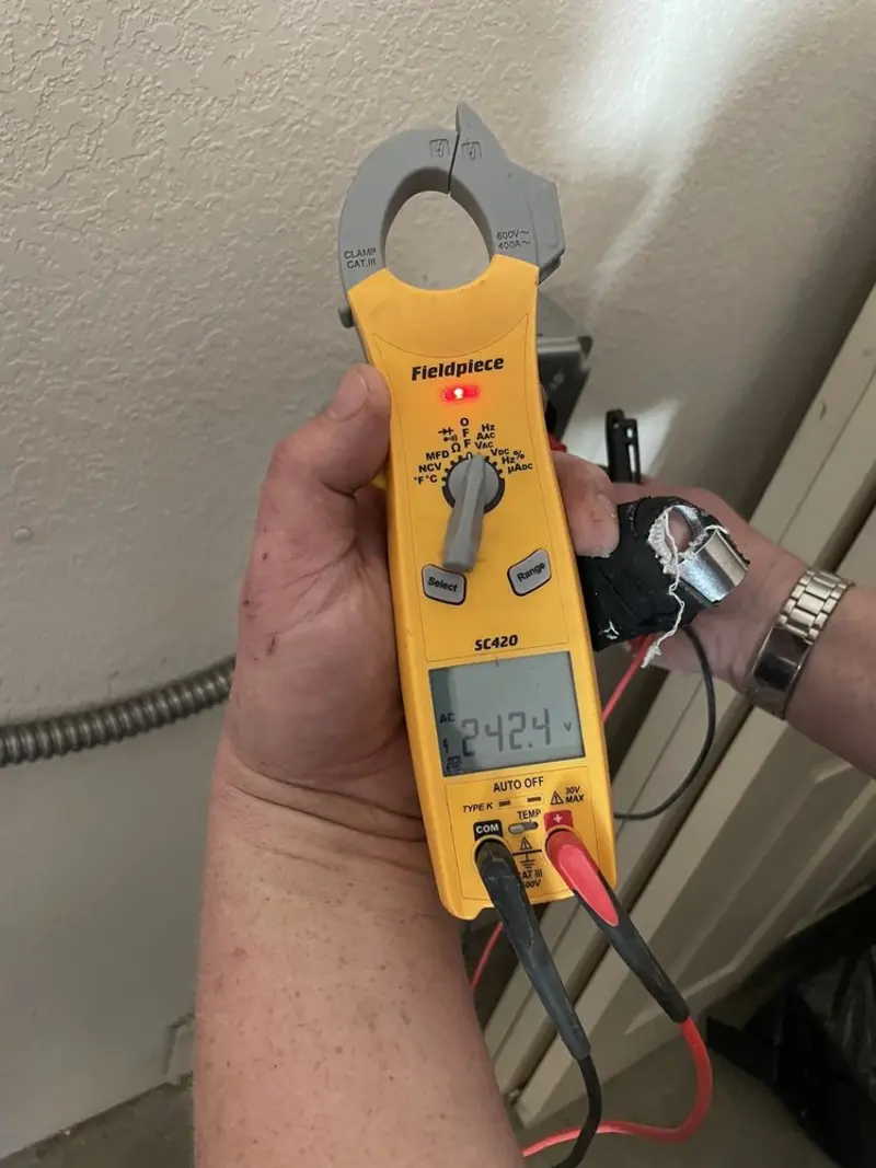 Voltage testing with clamp meter during Ceiling Fan Installation in Foster